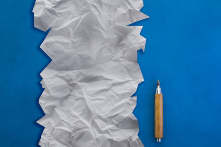 pencil on white crumpled paper and blue leather background creativity ideas cocneptの写真素材