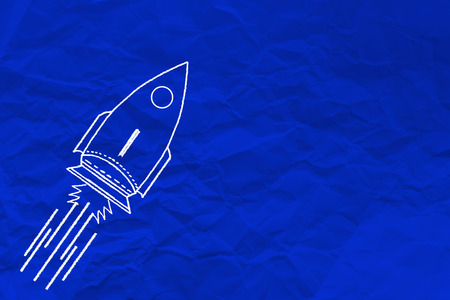 hand writing rocket on blue crumpled paper , business creativity idea conceptの写真素材