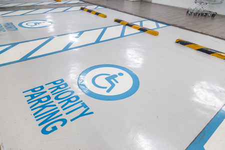 The international markings for a handicapped parking stall in a parking lot.
