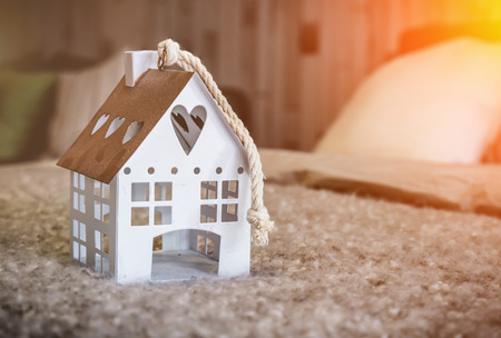 home sweet home house model on fabric  beige color with light flare effectの写真素材