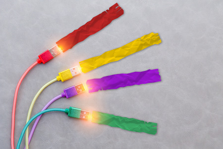 paper note with USB Cable with red cable yellow cable purple cable and green color cable on grey...