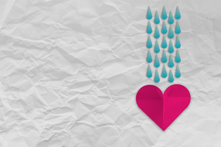 heart shape paper with drop water of rain icon on Crumpled fold white paper sheet backgroundの写真素材