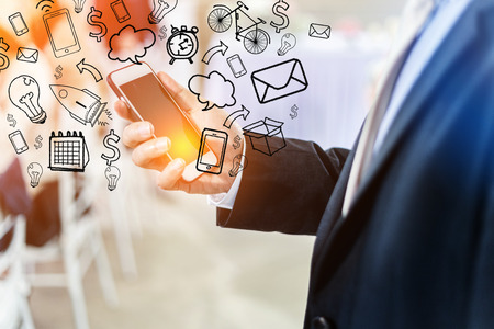 closed up business man using smartphone for connecting prople in business success conceptの写真素材