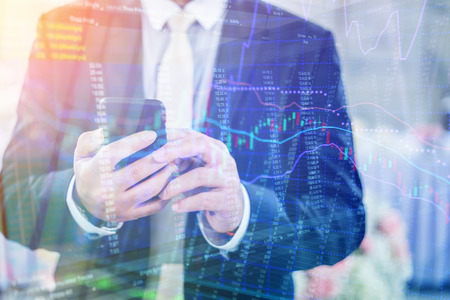 Double exposure of business finance stock graph analysis and businessman on the phone as Business development concept.の写真素材
