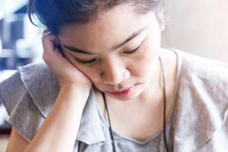 Thinking business woman with free copy space in cafe background with finger at face, asian beautyの写真素材