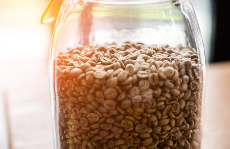 roasted coffee beans,Coffee beans in glass jar on wooden background.の写真素材