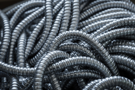 Flexible metal pipe on a white background.の写真素材