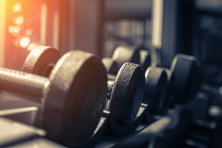 Rows of dumbbells in the gym with hign contrast and monochrome color toneの写真素材