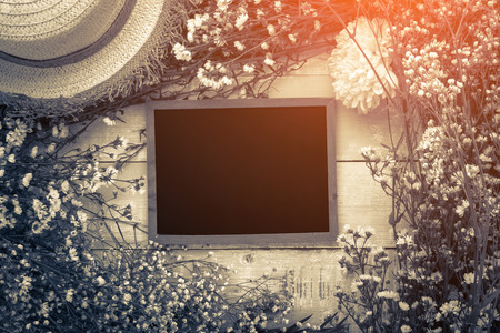 Beautiful blossom branch with framed blackboard over wooden backgroundの写真素材