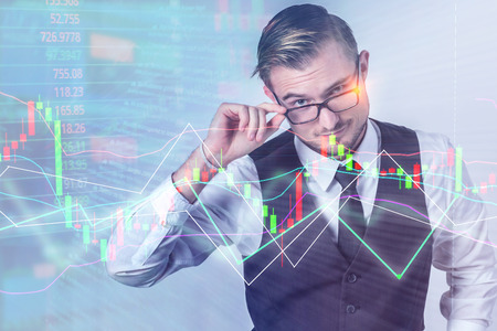 expert smart businessman studying a high technology holographic chart of worldwide financial and...
