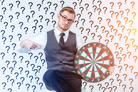 Businessman holding dartboard - business targeting symbolic conceptの写真素材