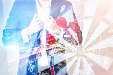 closed up business man using smartphone for connecting prople in business success concept with dartboard overlay dpuble exposureの写真素材