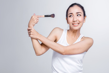 beauty asian girl try to escape from cosmetic makeup on white background  beauty conceptの写真素材