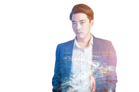 Double exposure of night street and city and businessman with thinking action poseの写真素材