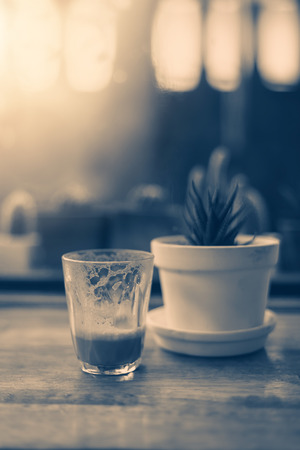 single empty glass of coffee espresso cup close up on the wooden tableの写真素材