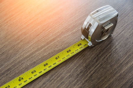 Tape measure on wooden laminate floorの写真素材
