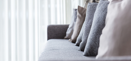 contemporary interior of Living room with part of sofa in sunny day and white curtain interior background conceptの写真素材