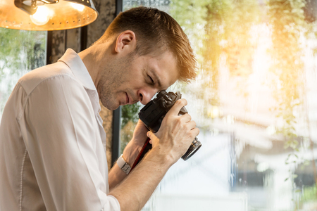 handsom american take a photo with concentrate and focus in shottingの写真素材