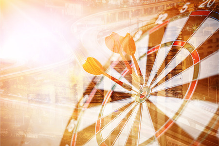 red three darts arrows in the target center business goal conceptの写真素材