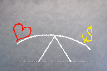love concept with drawing of love and money selection and compare on grey leather backgroundの写真素材