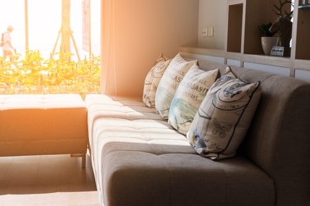 contemporary interior of Living room with part of sofa in sunny day and white curtain interior background conceptの写真素材