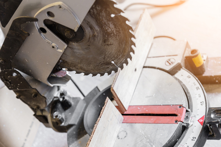 carpenter sawing wood work in workshop interior construction ideas conceptの写真素材