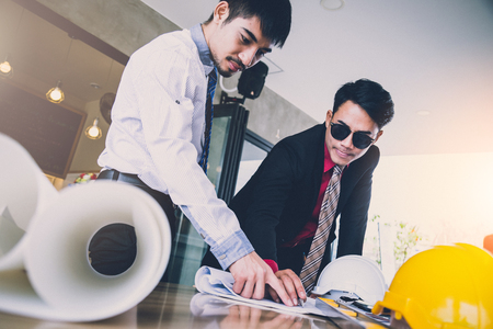 business man consult meeting with engineer or architect with cafe backgroundの写真素材