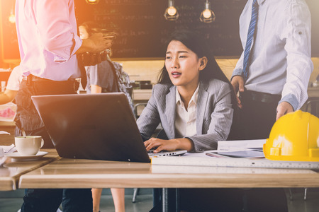 smart asian business woman working on table top with laptop paper coffee smartphoneの写真素材