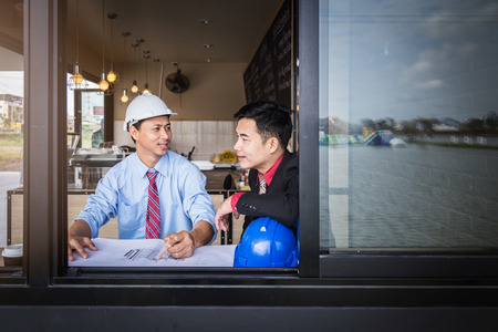 business man consult meeting with engineer or architect with cafe backgroundの写真素材