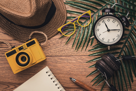 summer vacation background concept with travel stuff items on wooden table background color tone...