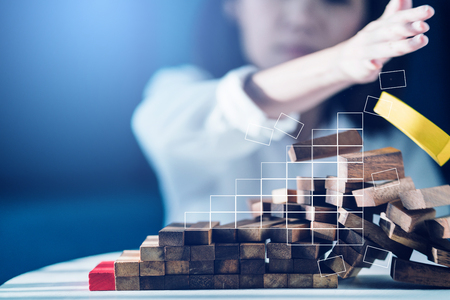 business failuare ideas concept with girl hand smash wooden stack block on ground with angerの写真素材