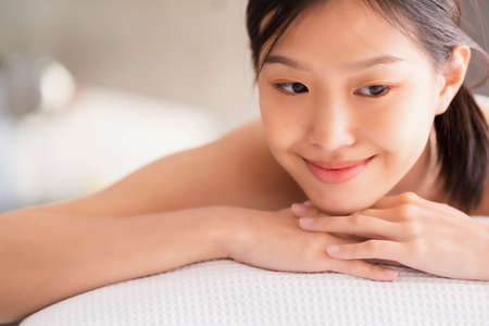 attractive asian woman enjoy and clam oriental massage therapy white bed healthy life ideas conceptの写真素材