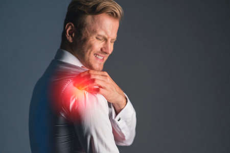 stress caucasian businessman officer feel bad with work hard and office syndrome hand touch painful body partの写真素材