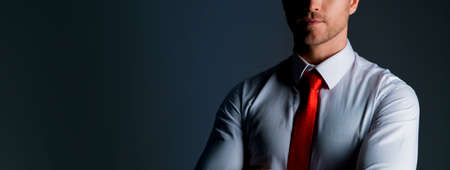 smart caucasian businessman white shirt portrait half body dark color backgroundの写真素材
