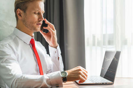 smart caucasian businessman concentrate focus working with laptop and smartphone office background