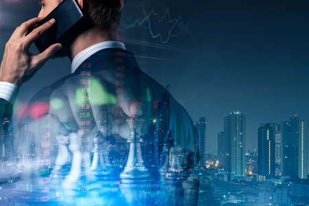 smart caucasian businessman black suit hand hold speaking smartphone with chess board virtual icon...