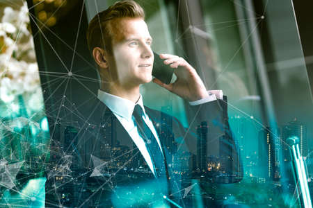 smart handsome caucasian executive officer work and contact client with smartphone office building...