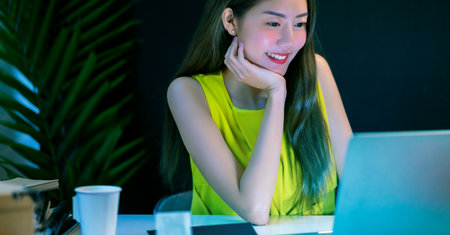Asian female businesswoman working hard late together with technology computer in office, customer...
