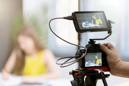 close up camera gear shooting attrative asian female business woman yellow casual dress enjoy...
