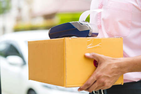 delivery ideas concept close up indian messenger handle package product to customer with happiness and cheerful house door entranceの写真素材