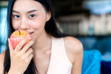 healthy pretty asian woman happiness enjoy eat and love diet with red fresh apple fruit weight loss...