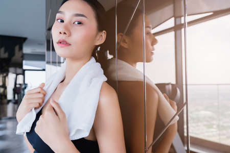 sport asian woman relax and take a brak after workout healthy fit and firm conceptの写真素材