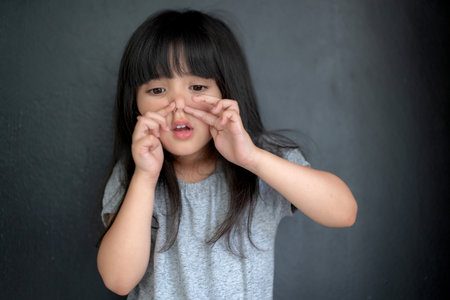 happiness black hair asian big eye girl portrait photo shoot with casual dress with fun on black...
