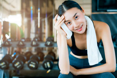 beautiful asian sport woman sitting relaxing after workout tried from exercise weight training healthy ideas conceptの写真素材