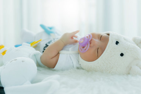 cute infant baby boy sleep with sweet dream and peaceful white soft bedの写真素材
