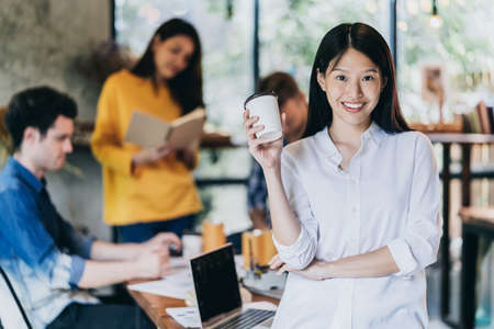 attractive asian woman smile with happiness and confident with teamwork meeting backgrond startup ideas conceptの写真素材