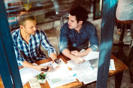 creative business meeting with caucasian and asian co worker discuss with paper laptop and happiness...
