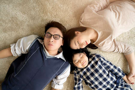 happy Asian Family mother father and daughter making a fun sleep play in living room home...