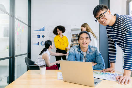 Group of asian young creative happy people entrepreneur on a business meeting office background Good...