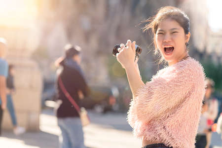 happy travel closeup asian woman hand sshoot camera traveller capture memory with background of famous landmark architecture,asian photographer travel with camera vacation conceptの写真素材